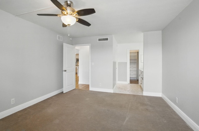 unfurnished bedroom with carpet floors, visible vents, and baseboards