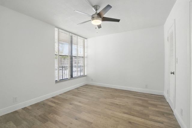 unfurnished bedroom with light wood-type flooring, baseboards, and ceiling fan