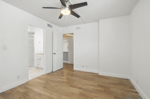unfurnished bedroom with baseboards, light wood-style floors, and visible vents