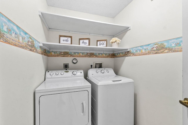 clothes washing area with washing machine and dryer, laundry area, and a textured ceiling