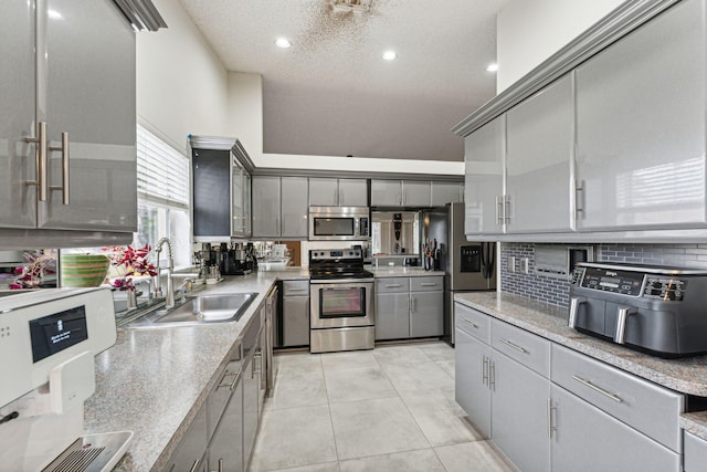 8004 Copenhagen Way, Boca Raton, FL 33434 - kitchen with stainless steel appliances, gray cabinets, a sink, decorative backsplash, and light tile patterned flooring