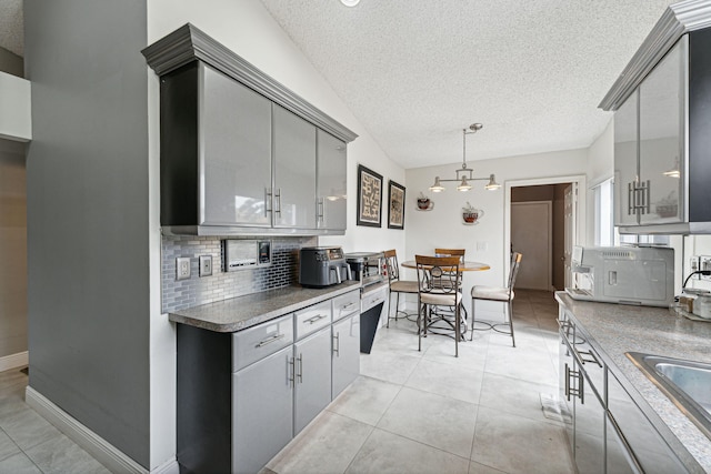 8004 Copenhagen Way, Boca Raton, FL 33434 - kitchen featuring gray cabinets, backsplash, a textured ceiling, a sink, and a chandelier