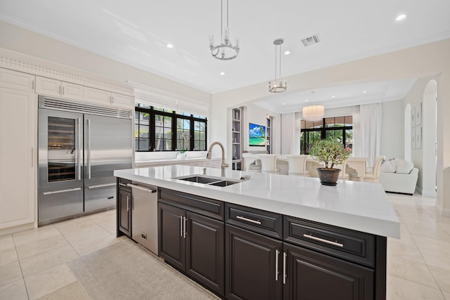 9650 Eden Mnr, Parkland, FL 33076 - kitchen featuring visible vents, a center island with sink, light countertops, a sink, and stainless steel appliances