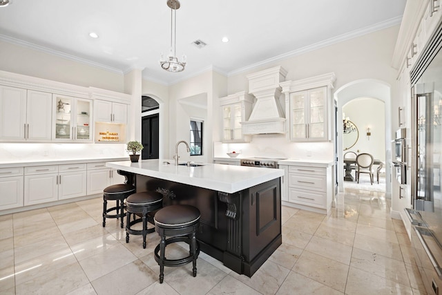 9650 Eden Mnr, Parkland, FL 33076 - kitchen featuring visible vents, arched walkways, light countertops, and ornamental molding