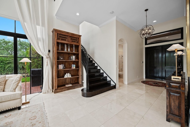 9650 Eden Mnr, Parkland, FL 33076 - entryway featuring arched walkways, stairway, a notable chandelier, ornamental molding, and recessed lighting