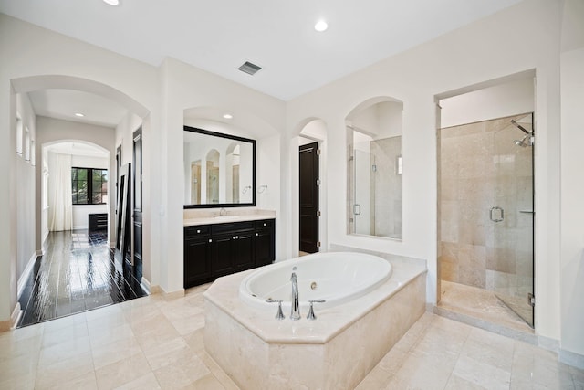 9650 Eden Mnr, Parkland, FL 33076 - full bath featuring visible vents, a shower stall, a tub with jets, vanity, and baseboards