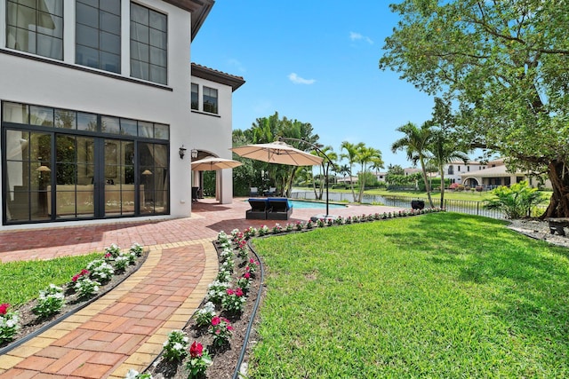 9650 Eden Mnr, Parkland, FL 33076 - view of yard featuring a water view, a patio area, an outdoor pool, and fence