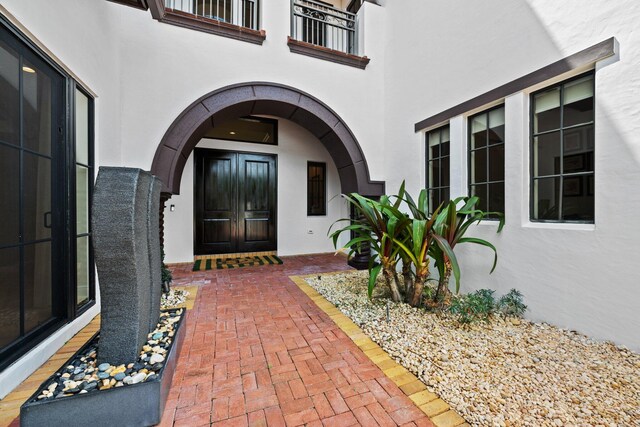 9650 Eden Mnr, Parkland, FL 33076 - entrance to property featuring a balcony, stucco siding, and french doors