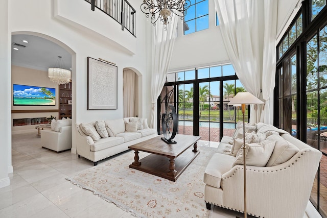 9650 Eden Mnr, Parkland, FL 33076 - living area featuring arched walkways, a notable chandelier, and a towering ceiling