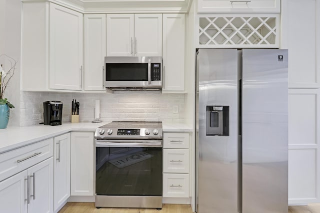 kitchen with decorative backsplash, stainless steel appliances, and light countertops