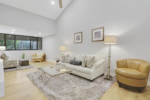 living area with recessed lighting, wood finished floors, baseboards, and ceiling fan