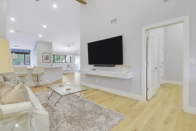 living area featuring recessed lighting, baseboards, visible vents, and light wood-type flooring