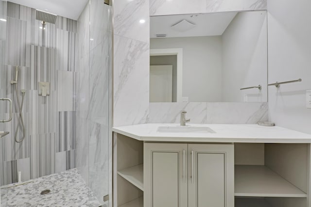 bathroom featuring a shower stall, vanity, and visible vents