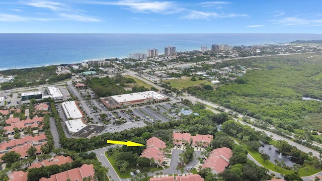 birds eye view of property featuring a city view and a water view