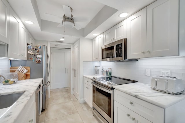 5279 Fountains Dr S Unit 304, Lake Worth, FL 33467 - kitchen featuring stainless steel appliances, a ceiling fan, tasteful backsplash, recessed lighting, and white cabinetry