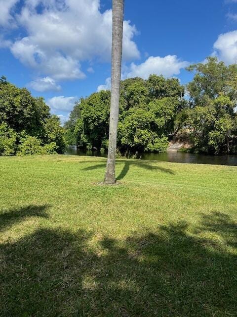 view of grassy yard with a water view