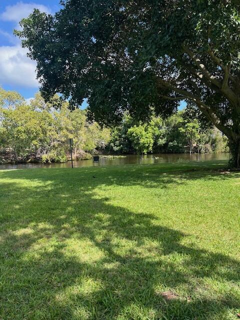 view of grassy yard with a water view