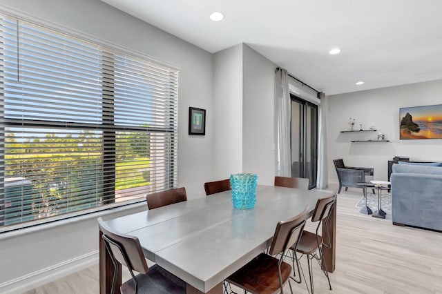 dining area with baseboards, light wood-style floors, and recessed lighting