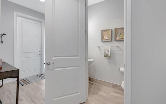 bathroom featuring wood finished floors and toilet
