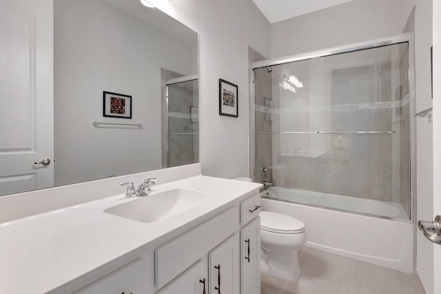 bathroom featuring toilet, vanity, and bath / shower combo with glass door