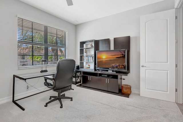 office space featuring carpet flooring, baseboards, and a ceiling fan