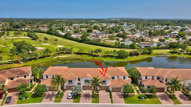 aerial view featuring golf course view, a residential view, and a water view