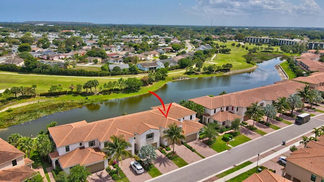 drone / aerial view with a residential view and a water view