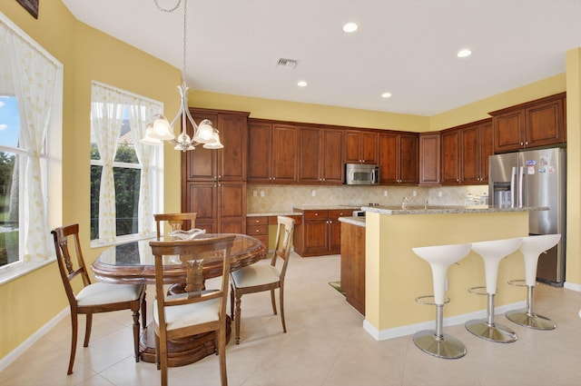 6863 Imperial Beach Cir, Delray Beach, FL 33446 - kitchen with stainless steel appliances, tasteful backsplash, a center island, recessed lighting, and hanging light fixtures