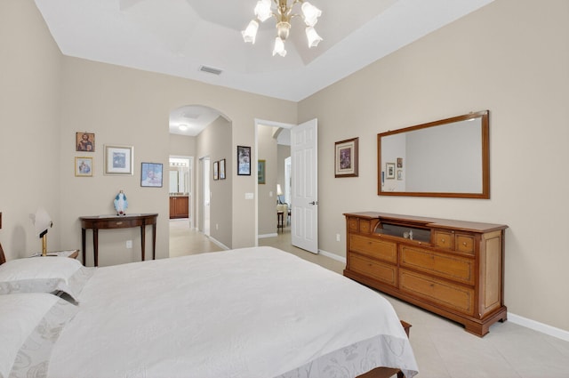 6863 Imperial Beach Cir, Delray Beach, FL 33446 - bedroom with arched walkways, baseboards, light tile patterned floors, and ensuite bathroom