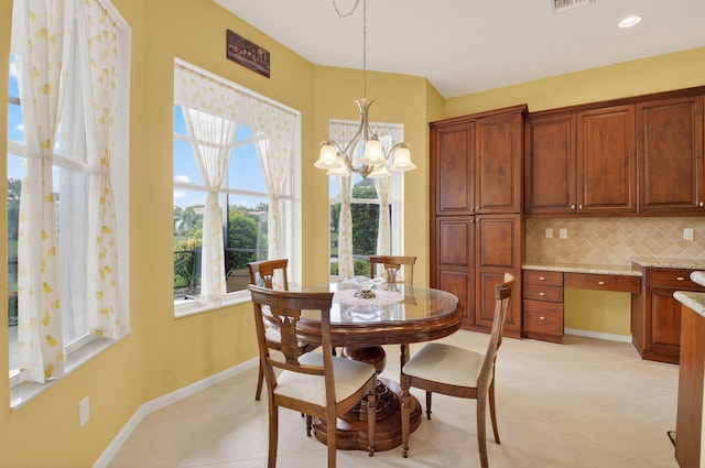 6863 Imperial Beach Cir, Delray Beach, FL 33446 - dining space featuring a chandelier, light tile patterned floors, and baseboards
