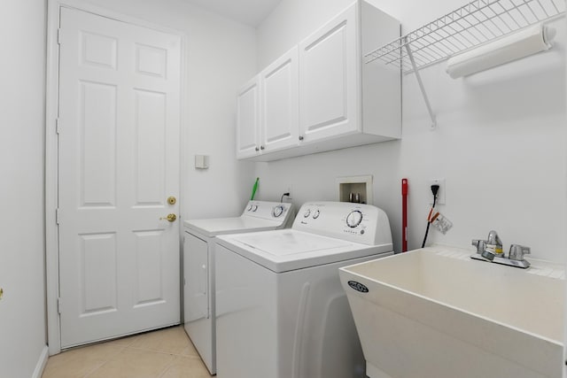 477 NW Blue Lake Dr, Port Saint Lucie, FL 34986 - washroom featuring cabinet space, washer and clothes dryer, and light tile patterned floors