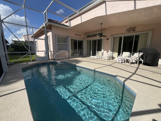 477 NW Blue Lake Dr, Port Saint Lucie, FL 34986 - outdoor pool with a patio area, glass enclosure, ceiling fan, and area for grilling