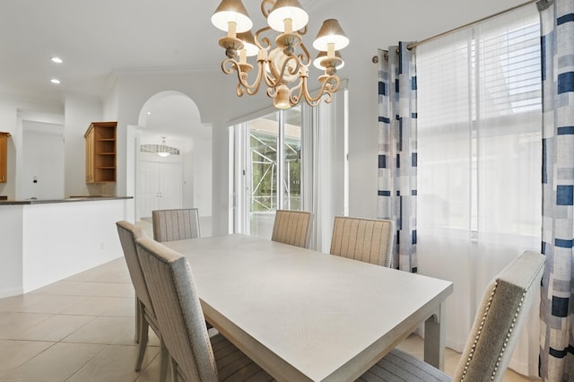 477 NW Blue Lake Dr, Port Saint Lucie, FL 34986 - dining space with a chandelier, crown molding, arched walkways, recessed lighting, and light tile patterned flooring