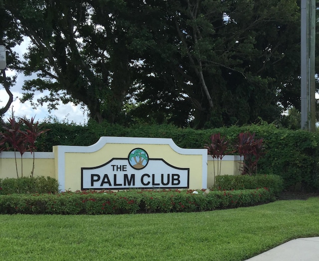 community / neighborhood sign with a lawn