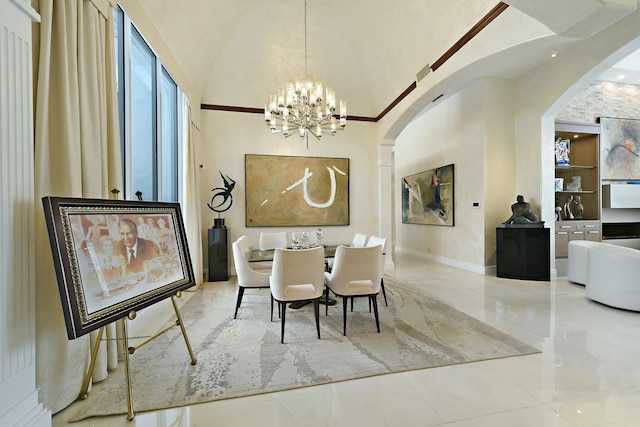 dining area featuring a chandelier, arched walkways, marble finish floor, and a towering ceiling