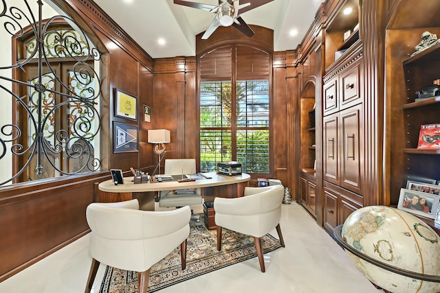 office with wooden walls and a ceiling fan