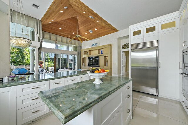 kitchen featuring visible vents, built in appliances, recessed lighting, a kitchen island, and light tile patterned flooring