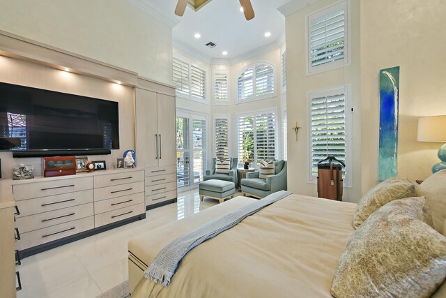 bedroom with access to outside, ceiling fan, a towering ceiling, ornamental molding, and tile patterned floors