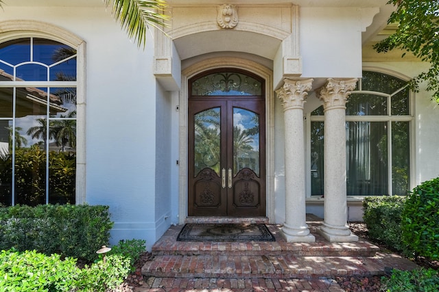 entrance to property with french doors and stucco siding