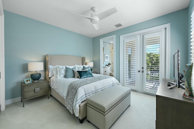 bedroom with visible vents, access to exterior, light colored carpet, and a ceiling fan