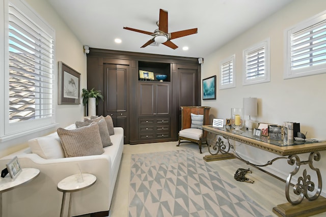 living area with a ceiling fan and recessed lighting