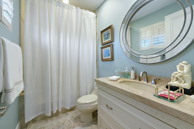 bathroom with toilet, vanity, and a shower with curtain