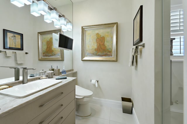 bathroom featuring tile patterned floors, toilet, vanity, and baseboards