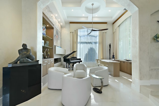 sitting room featuring coffered ceiling, arched walkways, recessed lighting, and a wealth of natural light