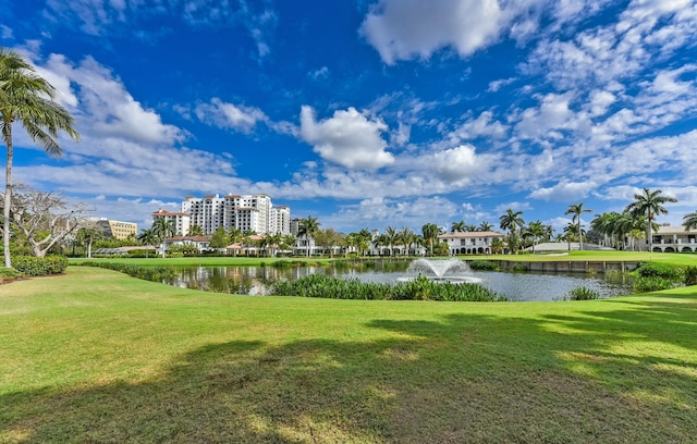 view of home's community featuring a water view and a yard