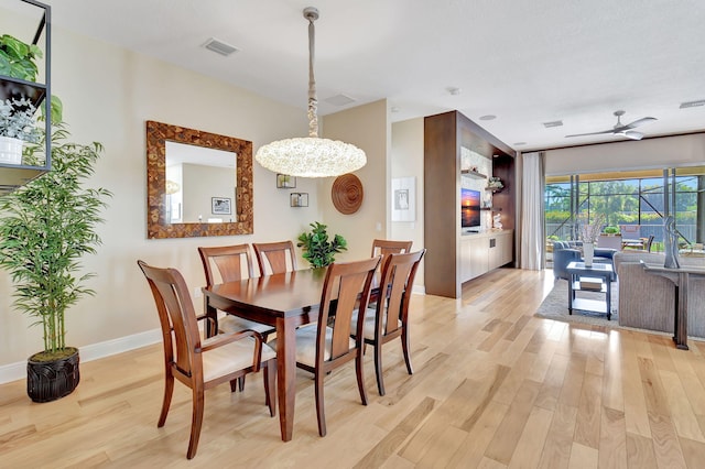 9380 Isles Cay Dr, Delray Beach, FL 33446 - dining area with light wood-style flooring, a ceiling fan, baseboards, and a chandelier