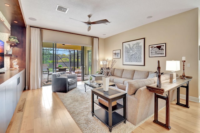 9380 Isles Cay Dr, Delray Beach, FL 33446 - living area with a ceiling fan, light wood finished floors, and a textured ceiling