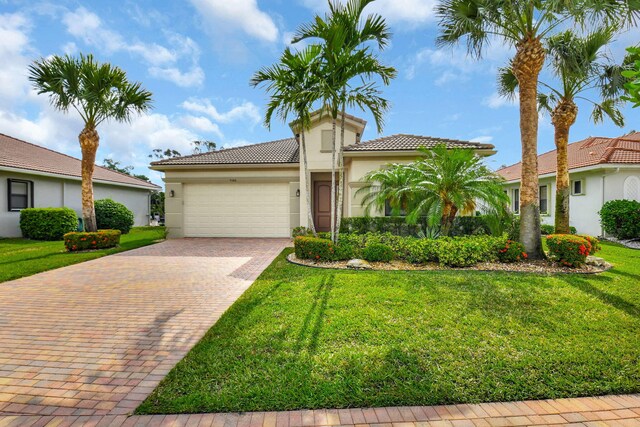 9380 Isles Cay Dr, Delray Beach, FL 33446 - mediterranean / spanish home with a garage, stucco siding, decorative driveway, and a tiled roof