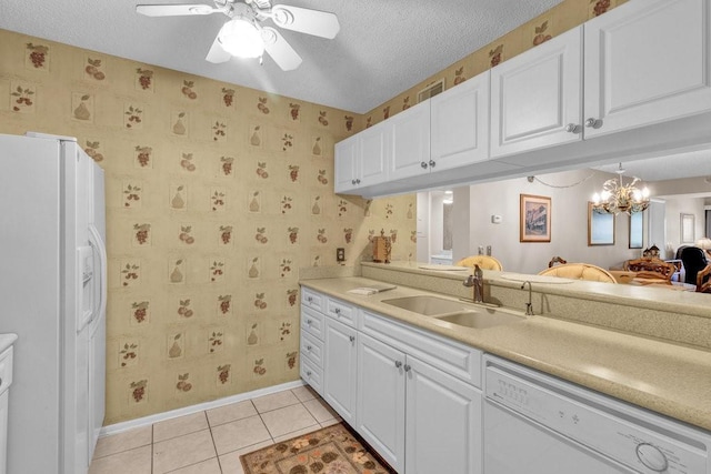 9 Plantation Dr Unit 104, Vero Beach, FL 32966 - kitchen featuring white cabinetry, a sink, white appliances, and baseboards