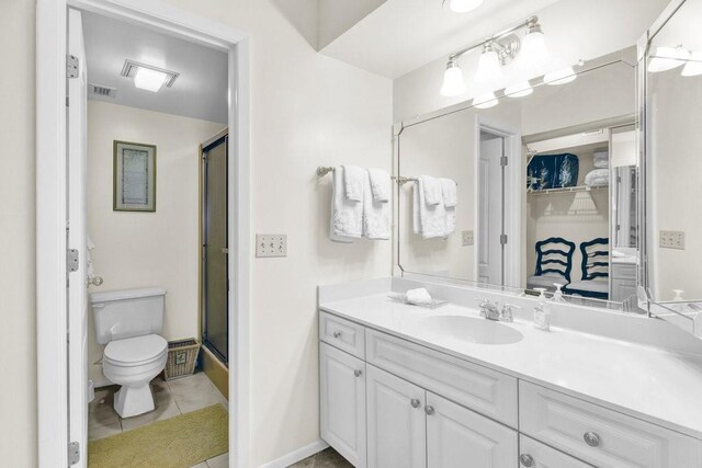 9 Plantation Dr Unit 104, Vero Beach, FL 32966 - bathroom with vanity, tile patterned floors, toilet, visible vents, and a shower with shower door